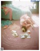 A woman laying on the floor next to a bed.