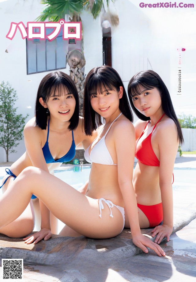 A group of three women in bikinis sitting next to a pool.