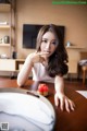 A woman sitting at a table with a plate of food.